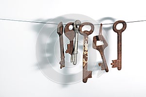 A different old retro rusty keys from different locks hanging on string