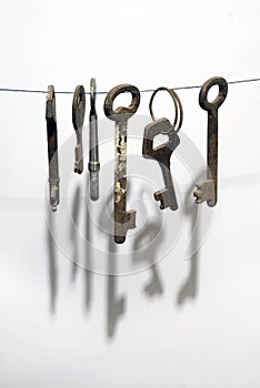 A different old retro rusty keys from different locks hanging on string