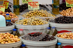 Different olives and olive oil on display at farmer`s market