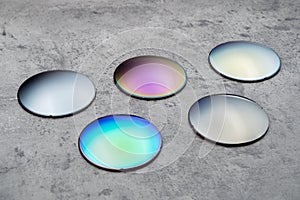 Different optical lenses on table in opical workshop