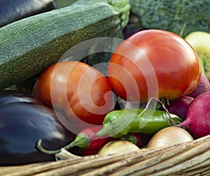 Different Organic Fruits and vegetables in basket on wooden table back