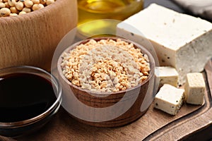 Different organic soy products on wooden board, closeup