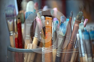 Different painting brushes in paiter`s atelier. Close-up.