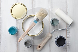 Different painting supplies on white wooden table