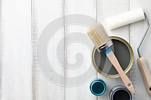 Different painting supplies on white wooden table