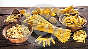 Different pasta types on wooden table.