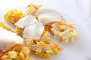Different pasta on a white plate