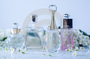 Different perfume bottles and flowers