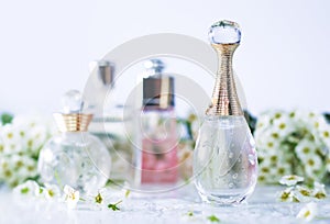 Different perfume bottles and flowers