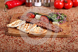 A different photo of a full-service Orfa Turkish Roast with green peppercorns and vegetables on a white plate over a table full of