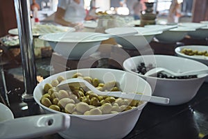 Different pickled olives at plates