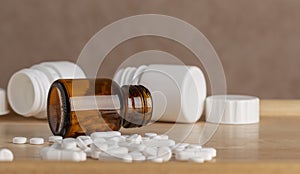 Different pill bottle and white pills