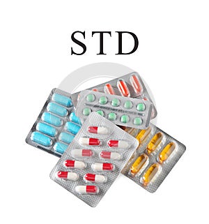 Different pills and abbreviation STD on white background