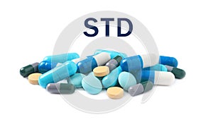 Different pills and abbreviation STD on white background
