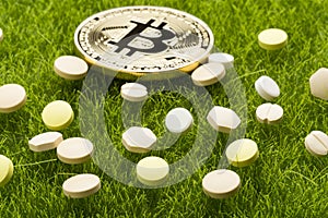 Different pills and bitcoin coin - healthcare cost concept