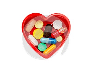 Different pills in box in shape of heart