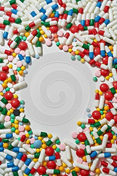 Different pills, capsules scattered in the shape of circle over white background. Health care, vitamins and treatment