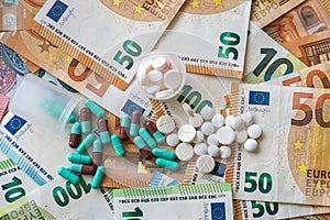 different pills on euro bills as background