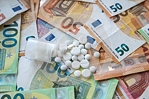 different pills on euro bills as background