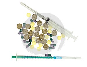 The different pills and syringes on white