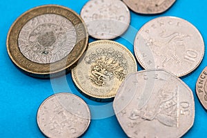 Different Pound coins on a blue