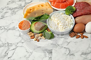 Different products rich in protein on marble table