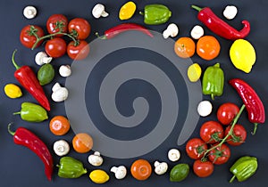 Different raw vegetables and spices on black background. Healthy eating. Autumn harvest and healthy organic food concept.