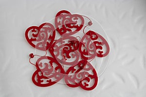 Different red heart shapes garland on whaite background