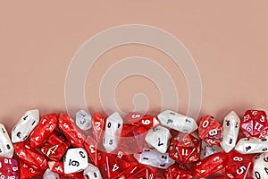 Different red roleplaying RPG dice at bottom of beige background