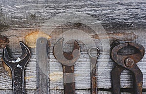 Different repair vintage tools and equipment border on wood background