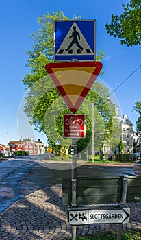 Different road signs with both priority sign and bike path sign