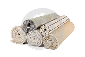 Different rolled carpets isolated on white