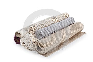 Different rolled carpets on white background