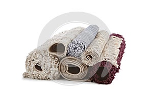 Different rolled carpets on white background