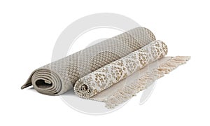 Different rolled carpets on white background