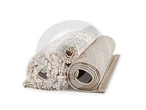 Different rolled carpets on white background