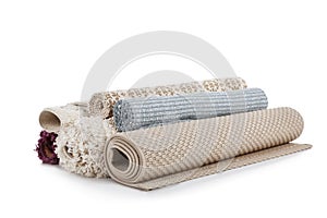 Different rolled carpets on white background.
