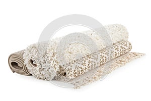 Different rolled carpets on white background.