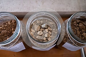 Different samples of soils in Climat of origin, grand cru wine tasting in underground cellars caves of French wine domain in photo