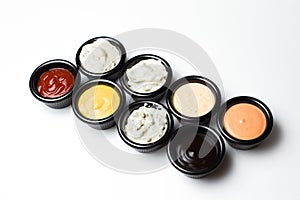 Different sauces in assortment in an black sauces