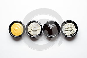 Different sauces in assortment in black sauces