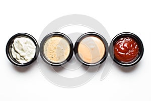 Different sauces in assortment in black sauces