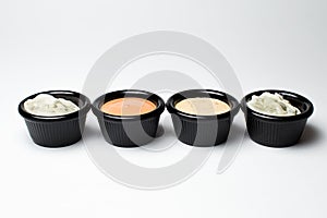 Different sauces in assortment in black sauces