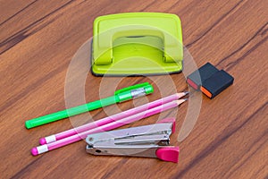 Different school office supplies on a wooden table