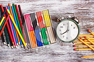 Different school supplies on the wooden background