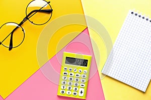 Different school tools on colorful paper copy space background