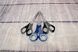 Different scissors on a wooden background.Close-up