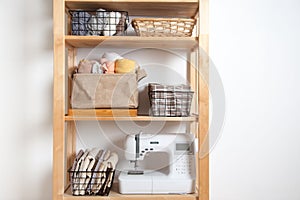 Different sewing supplies and yarn lie in baskets