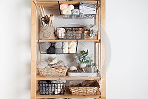 Different sewing supplies and yarn lie in baskets