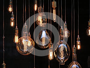 Different shaped vintage light bulbs on black background
